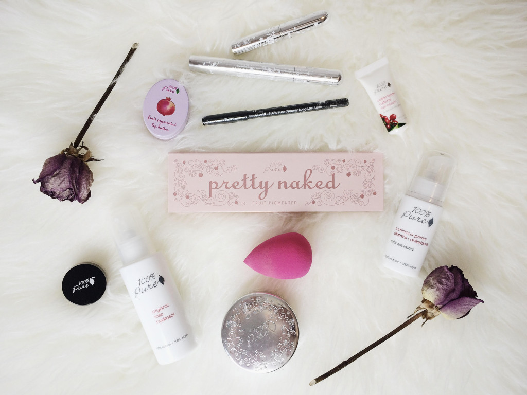 100 percent pure makeup items on white fur rug 