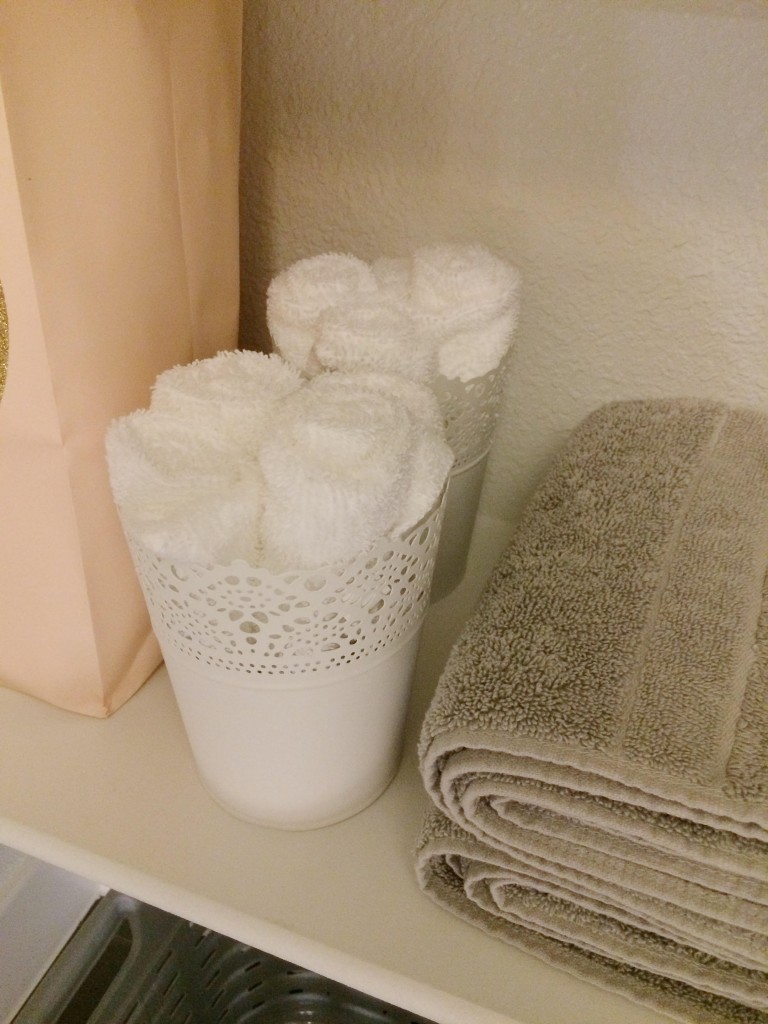 White Ikea pots with white washcloths rolled up inside