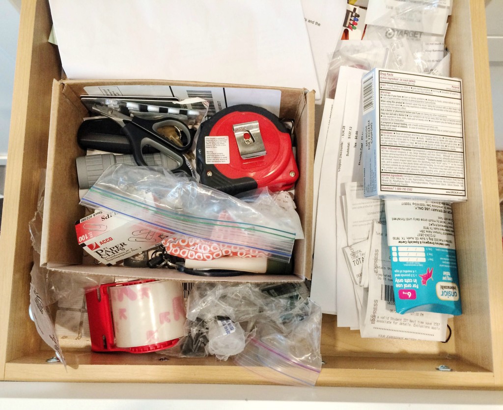 Before shot of clutter inside kitchen junk drawer