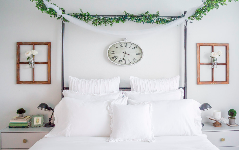 master bed with lots of white pillows on it