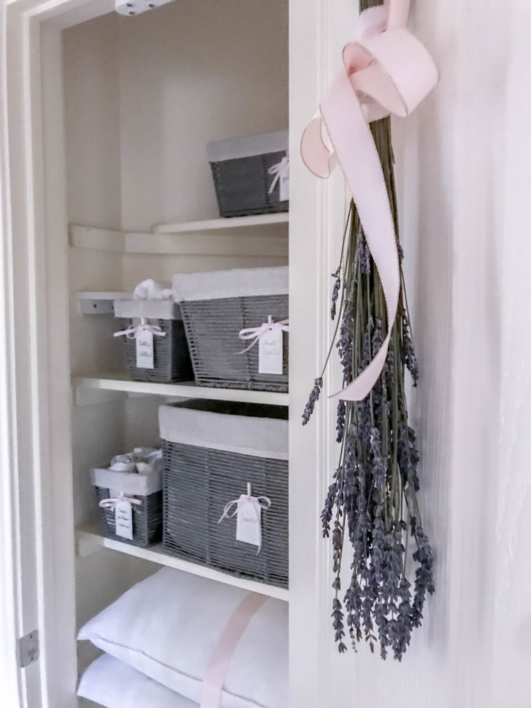 inside view of linen closet with lavender hanging on the door