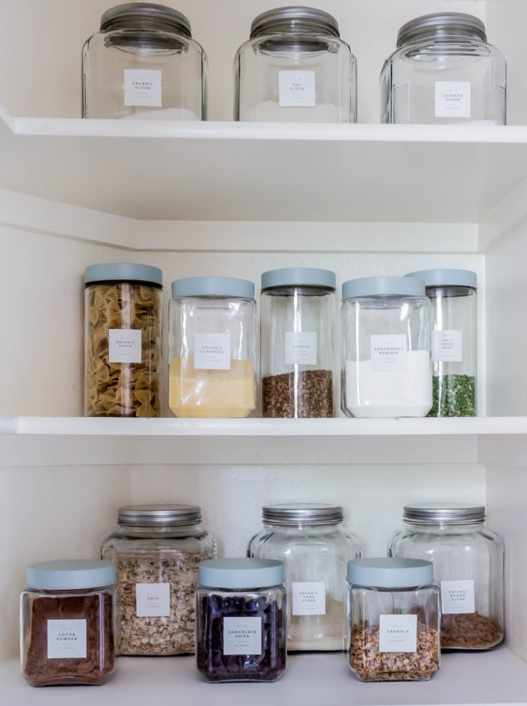 glass jars with labels filled with baking supplies