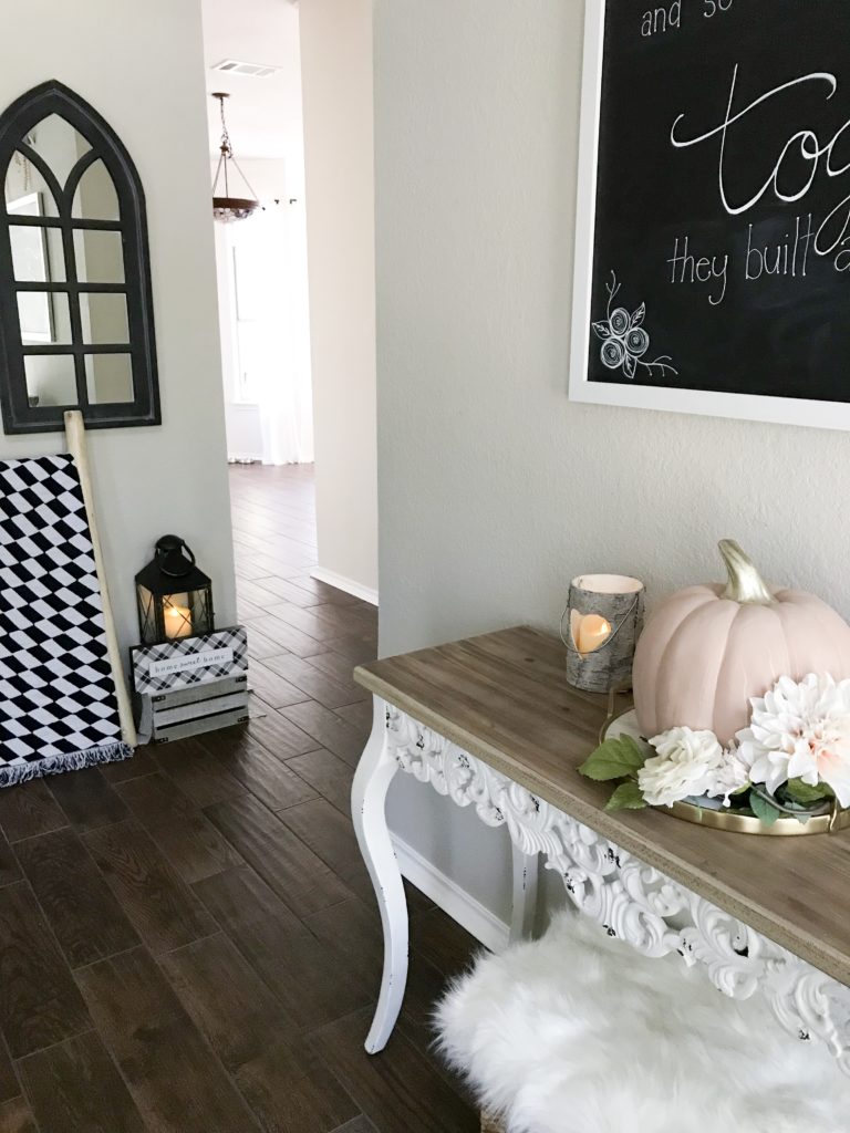 entryway to home with table and pink pumkpin