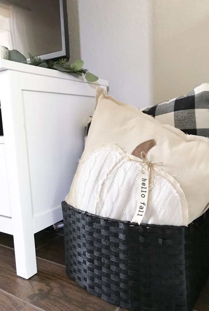 black basket filled with pillows